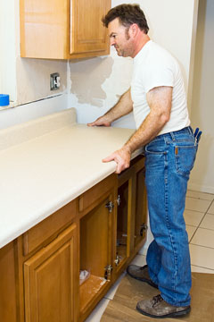 kitchen remodeling contractor installing cabinets and countertop